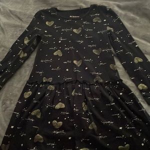 Black with sparkly gold hearts, white writings of hello in multiple languages